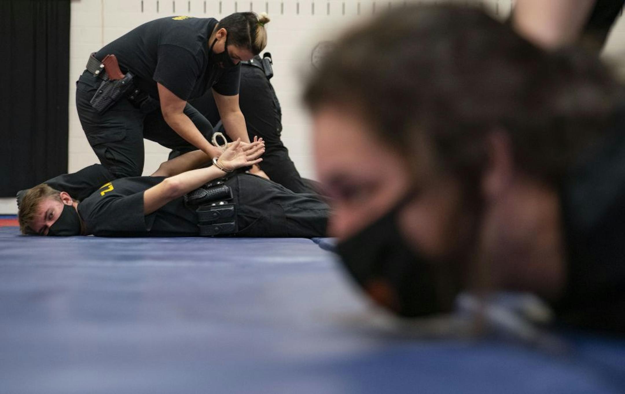 Law Enforcement trainee Mona Zeidan practiced handcuffing techniques on Zayne Anderson during defensive tactics class in the gymnasium at Fond Du Lac Tribal and Community College in Cloquet, Minn. on Tuesday November 17, 2020.