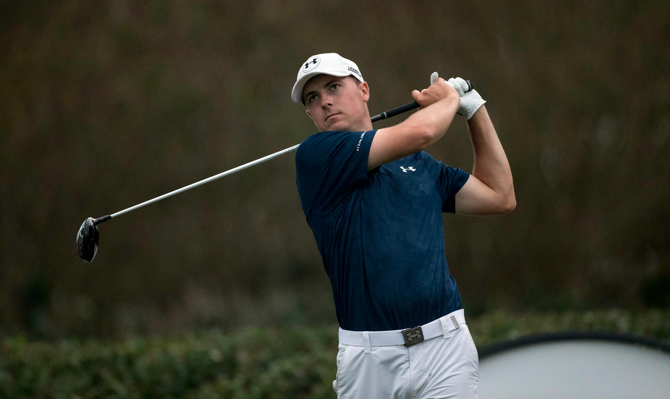 Jordan Spieth tees off on the 18th hole as dusk falls on the course during the second round of the Hero World Challenge golf tournament on Friday, Dec. 5, 2014, in Windermere, Fla. Spieth and Zach Johnson did not finish the 18th hole because of darkness. (AP Photo/Willie J. Allen Jr.)