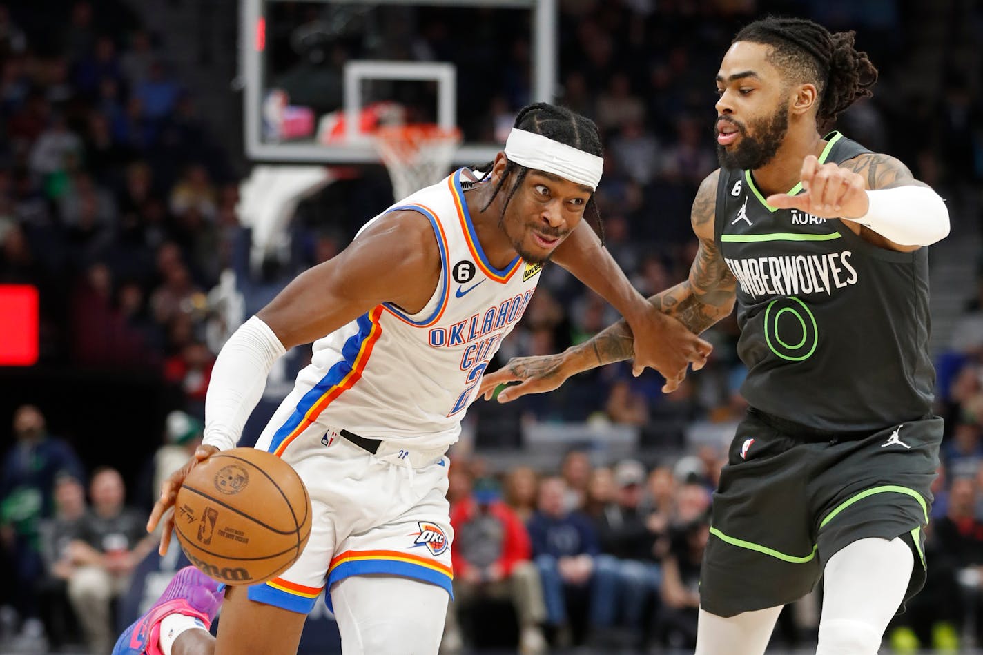 Oklahoma City guard Shai Gilgeous-Alexandegoes upcourt past Timberwolves guard D'Angelo Russell in the fourth quarter