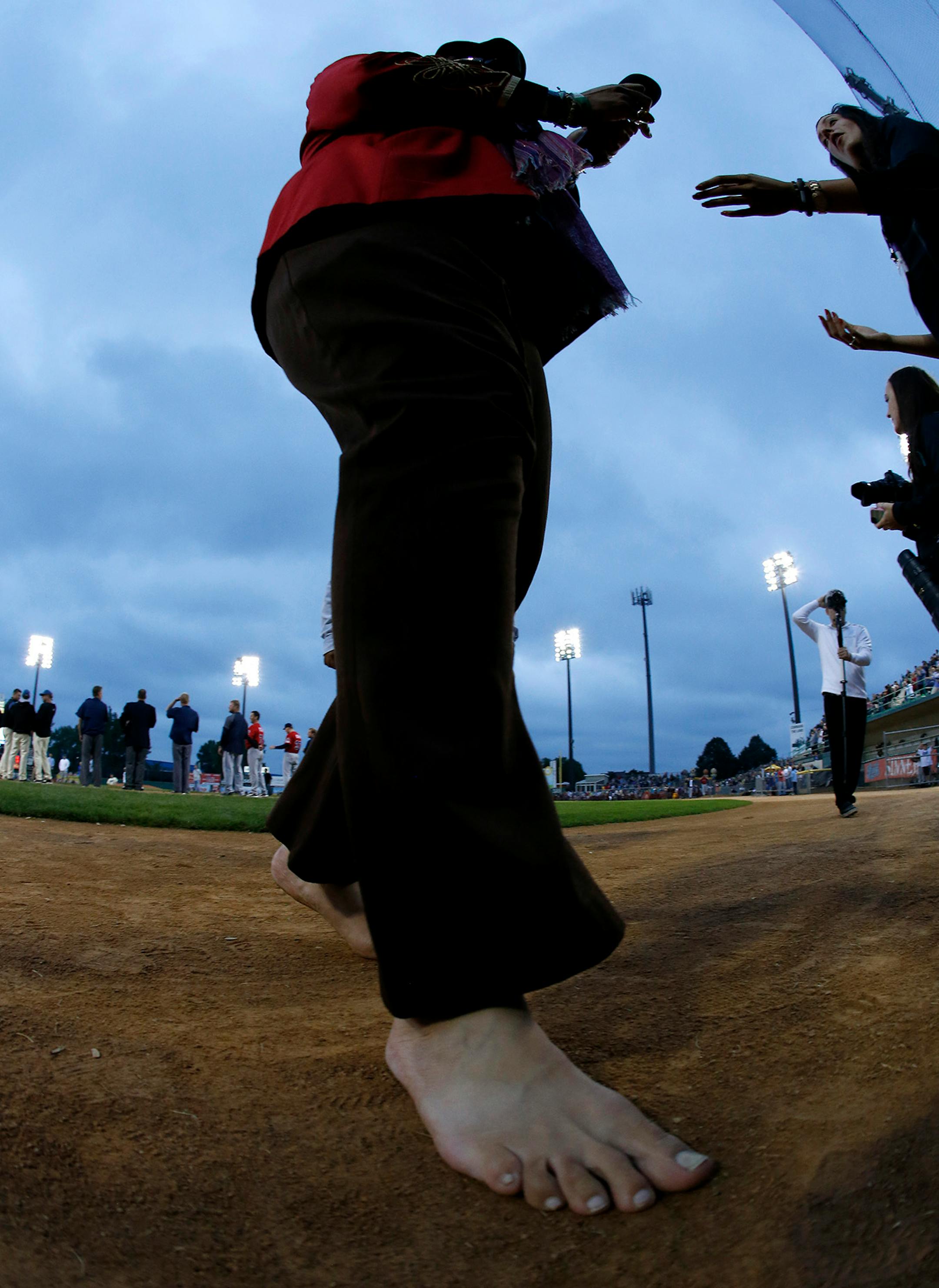 A barefoot Nicholas David returned the microphone after singing the National Anthem before the St. Paul Saints final game at Midway Stadium on Thursday night. ] CARLOS GONZALEZ cgonzalez@startribune.com - August 28, 2014, St. Paul, Minn., Midway Stadium, St. Paul Saints baseball vs. Winnipeg - Final Saints game at Midway Stadium