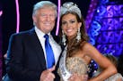Donald Trump (L) and Miss Connecticut USA Erin Brady pose onstage after Brady won the 2013 Miss USA pageant at PH Live at Planet Hollywood Resort & Ca