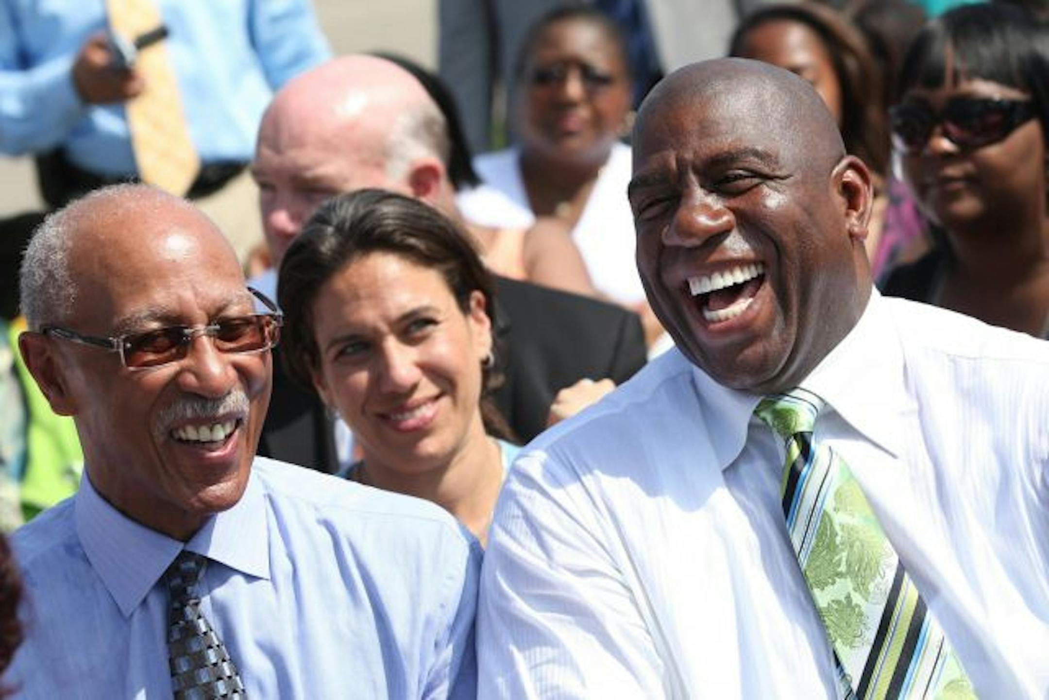 Detroit Mayor Dave Bing, left, and Earvin "Magic" Johnson share a laugh at Wayne State University Tom Adams Field, Wednesday, May 26, 2010, in Detroit, Michigan. They and several other leaders and celebrities gathered to speak to young people, including guest of honor first lady Michelle Obama.