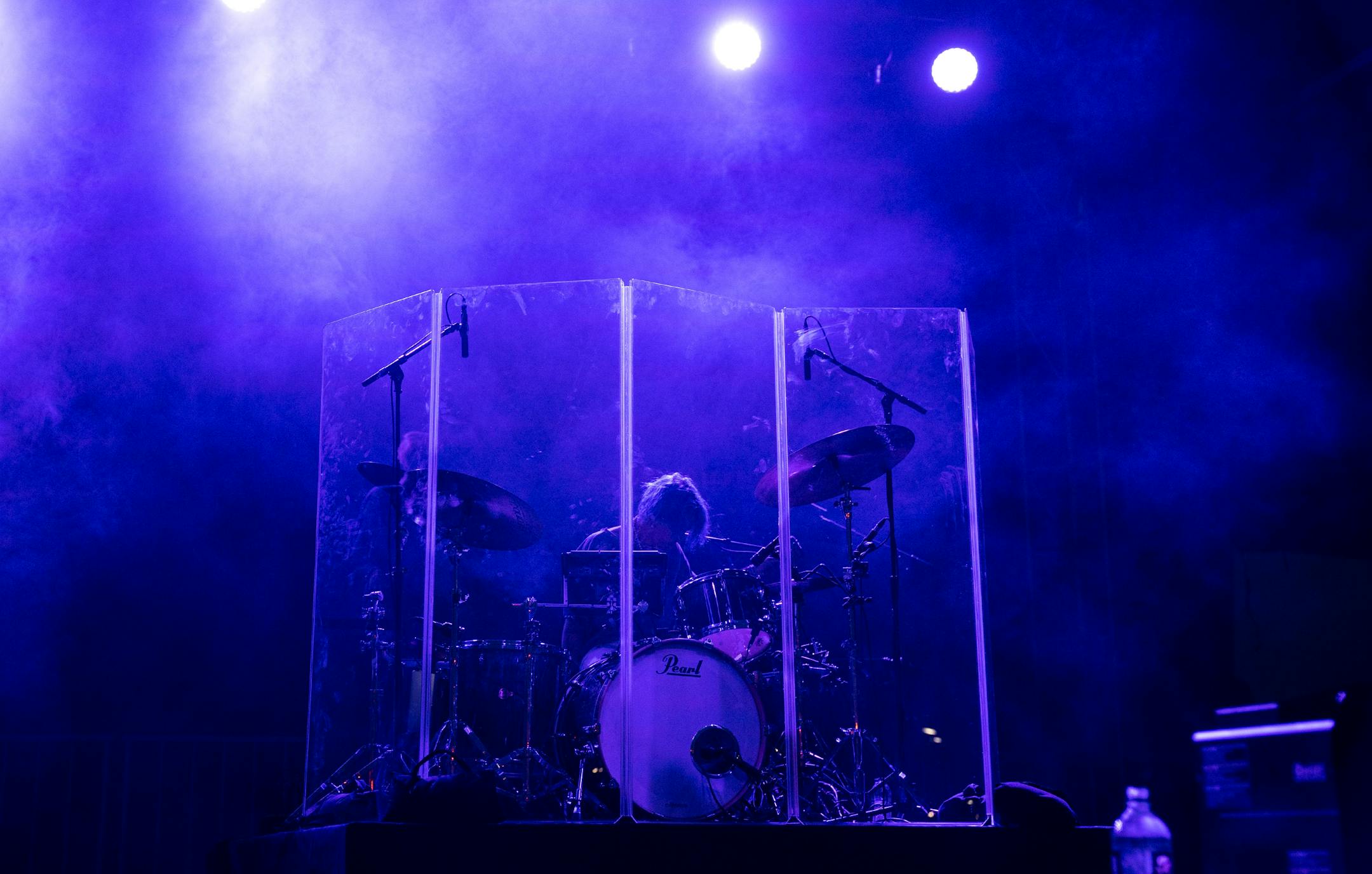 Carter Vaughan played drums behind a plexiglass barrier while Tate McRae performed Friday evening at the Basilica Block Party in Minneapolis.