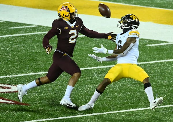 Iowa Hawkeyes wide receiver Ihmir Smith-Marsette (6) was unable to complete a pass as he was defended by Minnesota Gophers defensive back Phillip Howa