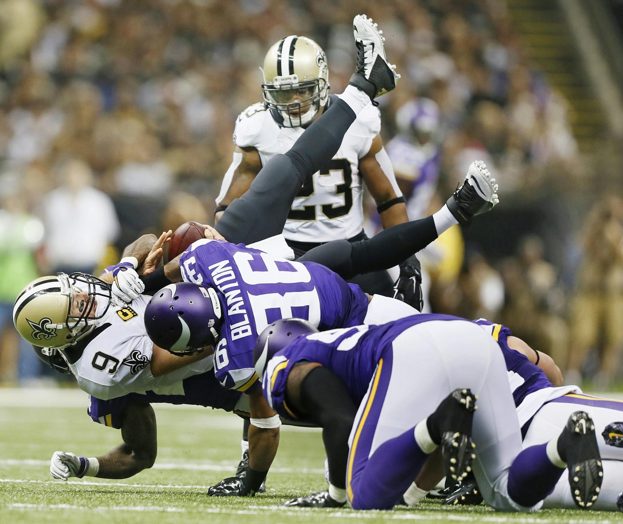 New Orleans Saints quarterback Drew Brees (9) was dumped by Minnesota Vikings cornerback Captain Munnerlyn (24) and strong safety Robert Blanton (36) in the third quarter . Munnerlyn was flagged for unnessary roughness on the play. The Minnesota Vikings played the New Orleans Saints at the Mercedes-Benz Superdome Sunday September 21 , 2014 in New Orleans ,LA. ] Jerry Holt Jerry.holt@startribune.com