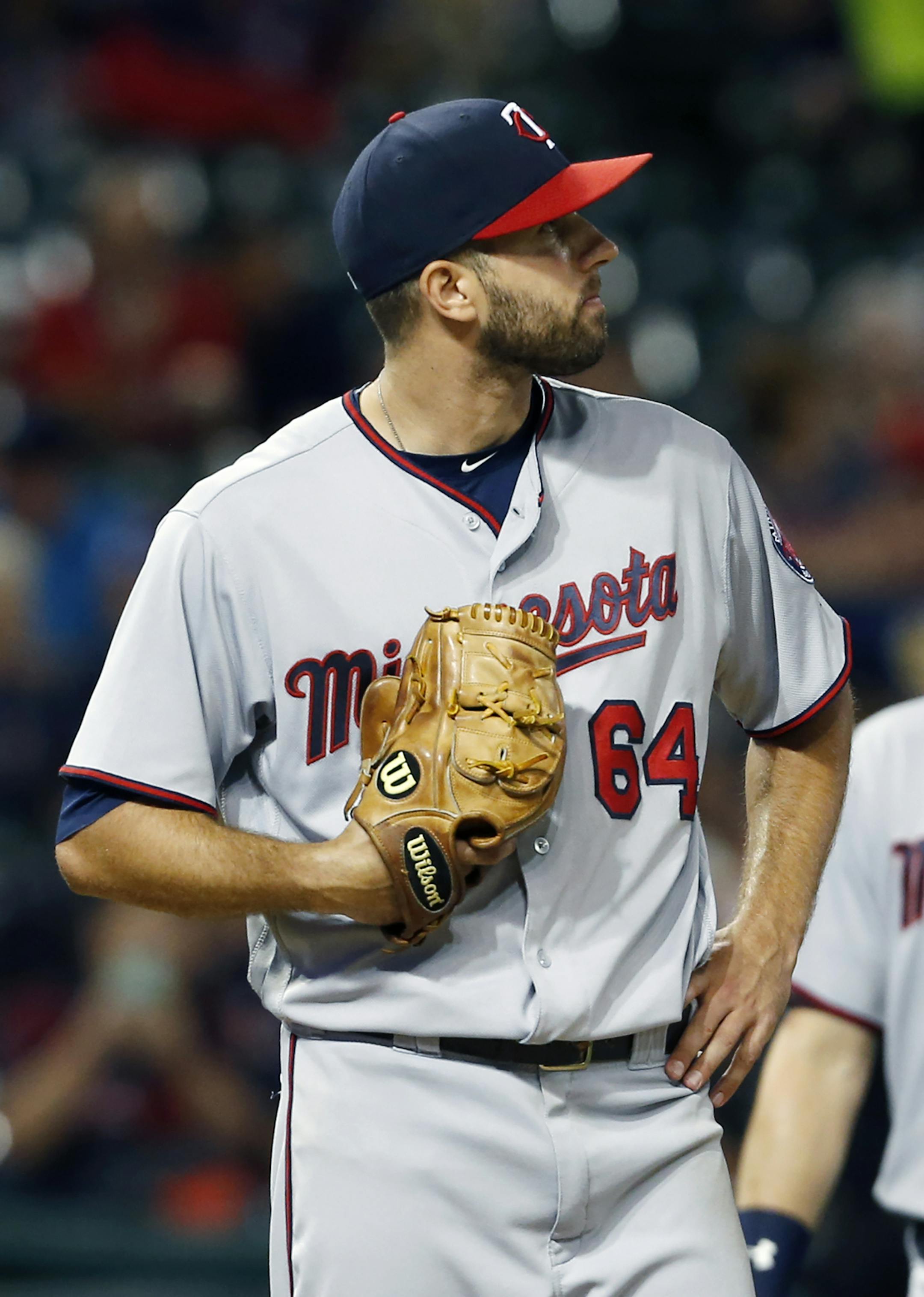 Minnesota Twins starting pitcher Pat Dean reacts after walking Cleveland Indians' Mike Napoli to load the bases during the fifth inning of a baseball game Wednesday, Aug. 31, 2016, in Cleveland. (AP Photo/Ron Schwane)