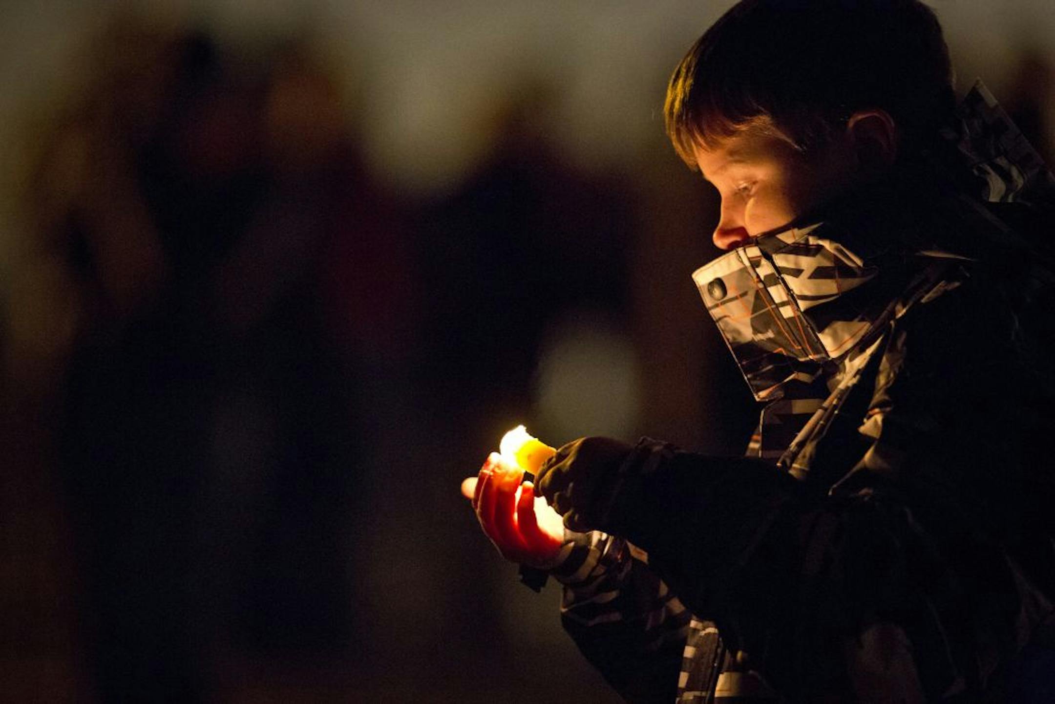 Austin Dockendorf held a candle at the end of a candlelight vigil in honor of Cold Spring police officer Tom Decker in Cold Spring, Minn., on Monday, December 3, 2012. Dockendorf's father is a fire fighter amd was family friends with the the Deckers.
