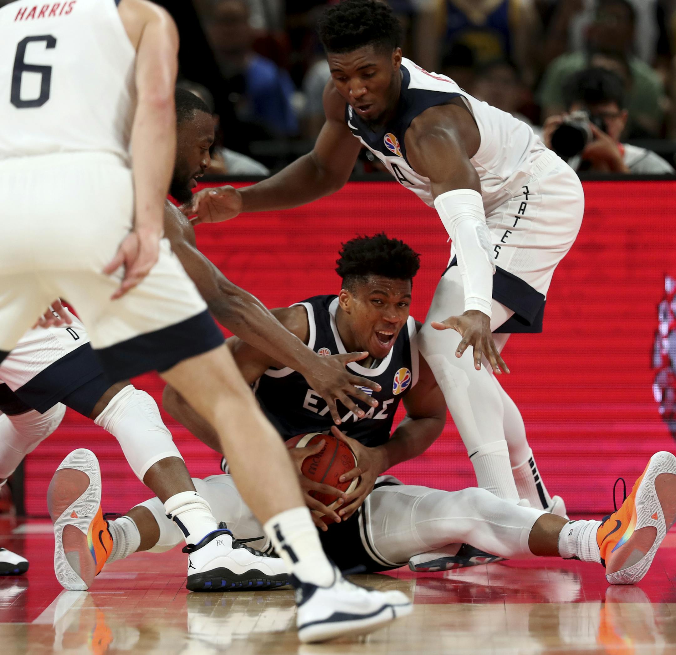 Greece's Giannis Antetokounmpo is surrounded by United States players as he fights to hold on to the ball during phase two of the FIBA Basketball World Cup at the Shenzhen Bay Sports Center in Shenzhen in southern China's Guangdong province on Saturday, Sept. 7, 2019. United States beats Greece 69-53. (AP Photo/Ng Han Guan)