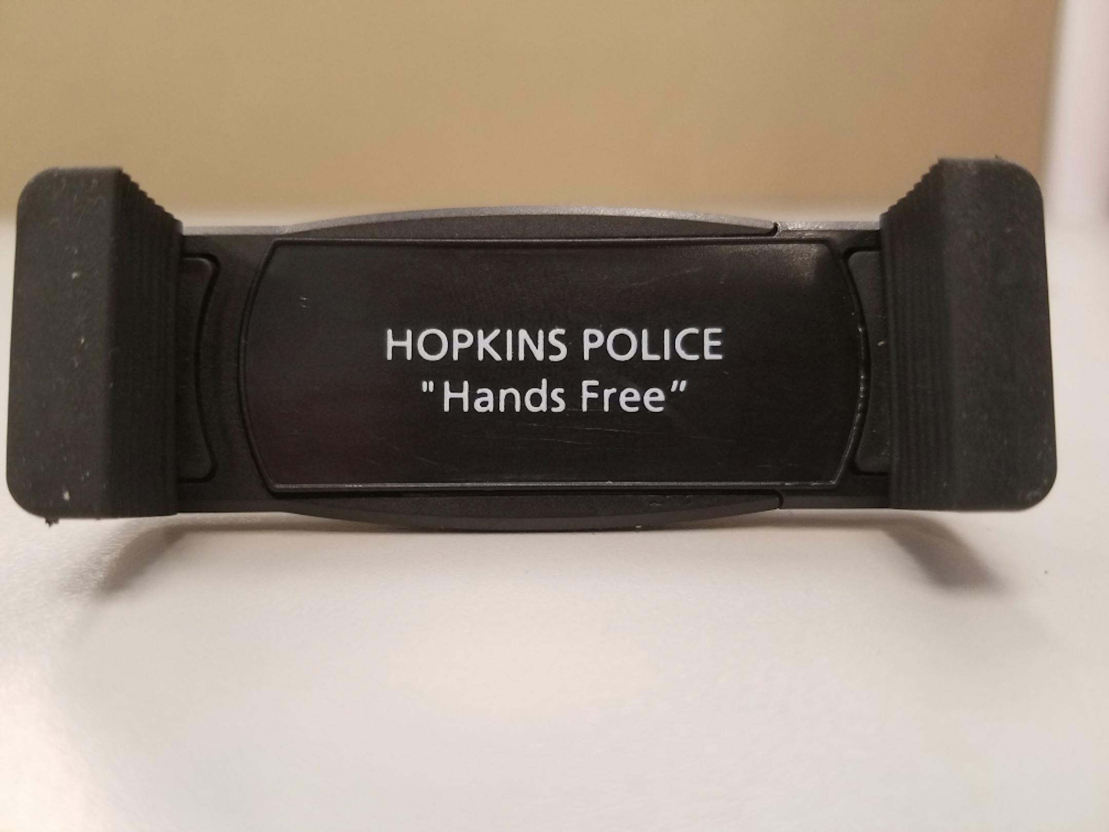 Hopkins police are giving out adjustable phone clips to help drivers go hands free when the new state law takes effect on Aug. 1.
