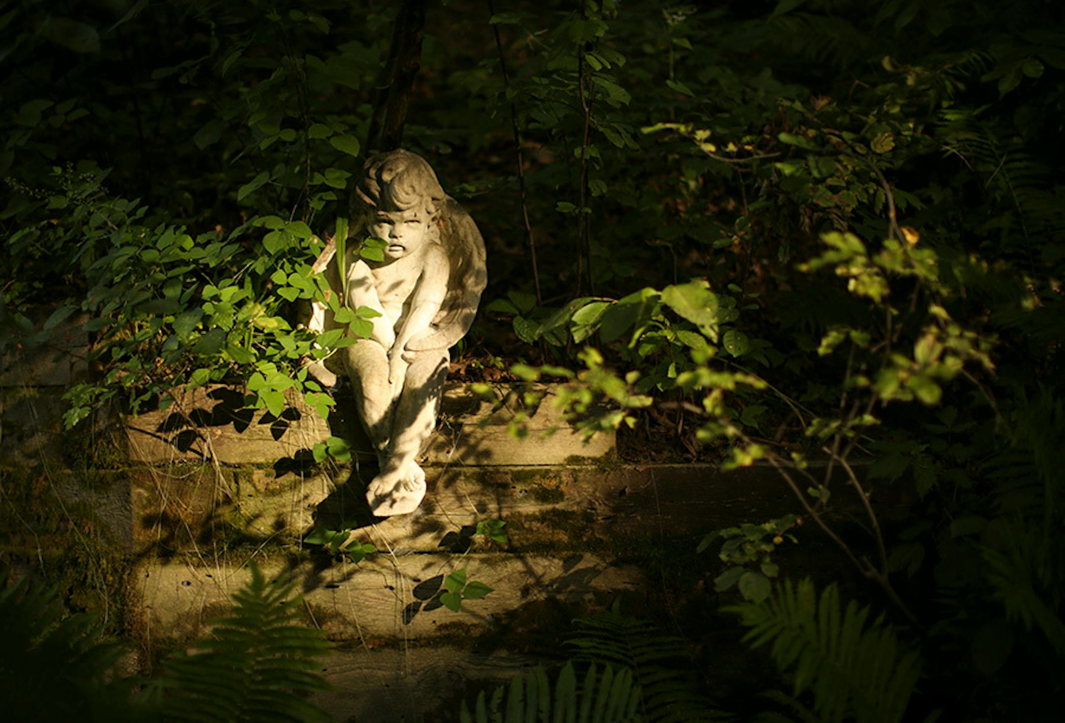 An angel figure was lit with a shaft of sunlight.