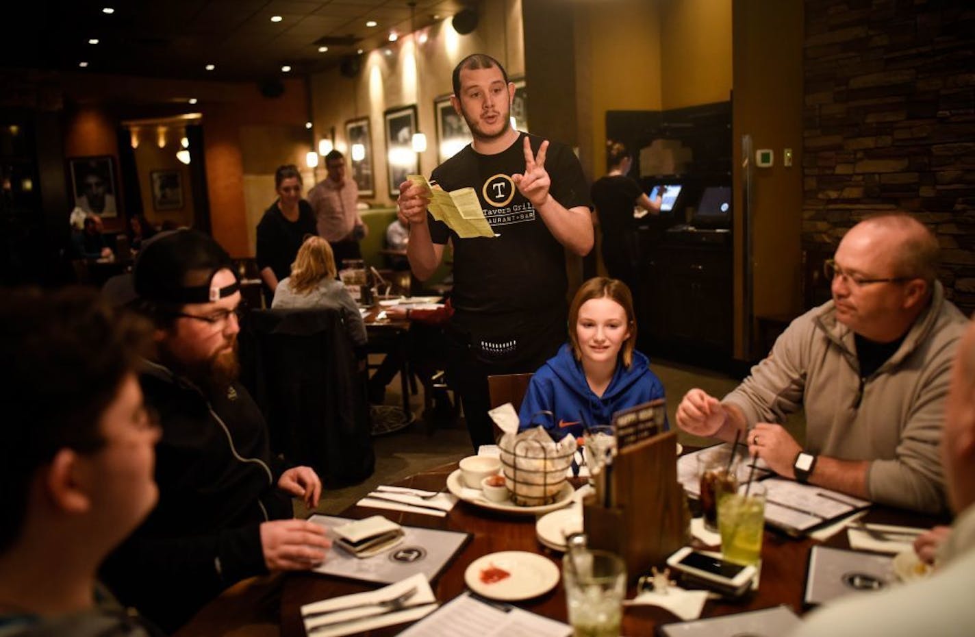 Colton Flores, a server with the Tavern Grill, took the Gooder family's dinner order Wednesday night.