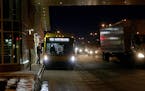 Commuters waited for and boarded busses at the Red Line's Apple Valley Transit Station on Cedar Ave., south of County Road 42 Wednesday afternoon. ] J