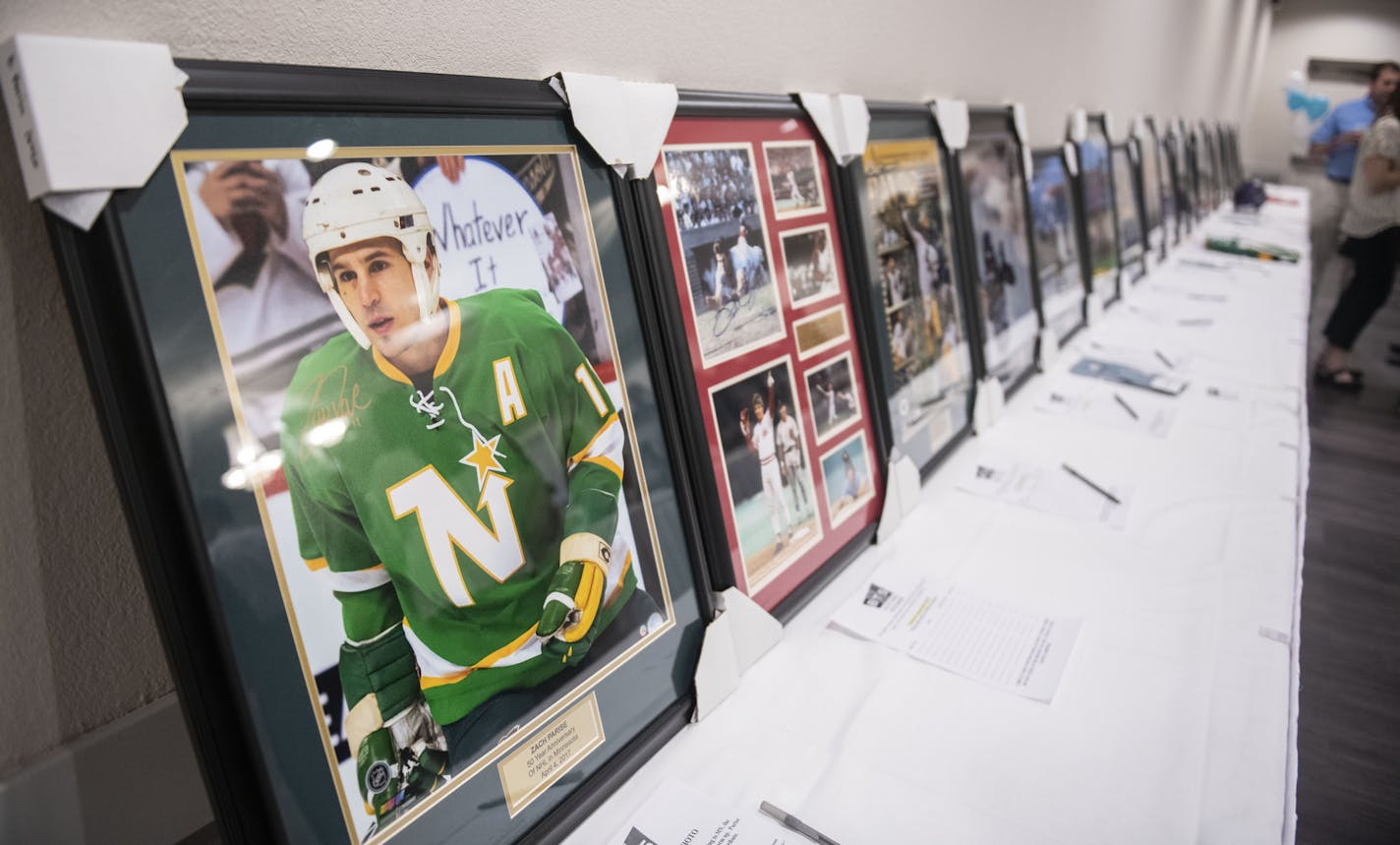 Silent auction pieces sat on display .] COURTNEY DEUTZ &#x2022; courtney.deutz@startribune.com on Saturday, May 4, 2019 at the Royal Cliff Banquet & Conference Center. Former NFL star Matt Birk held a fundraiser for a Catholic high school he is starting called Unity High School.