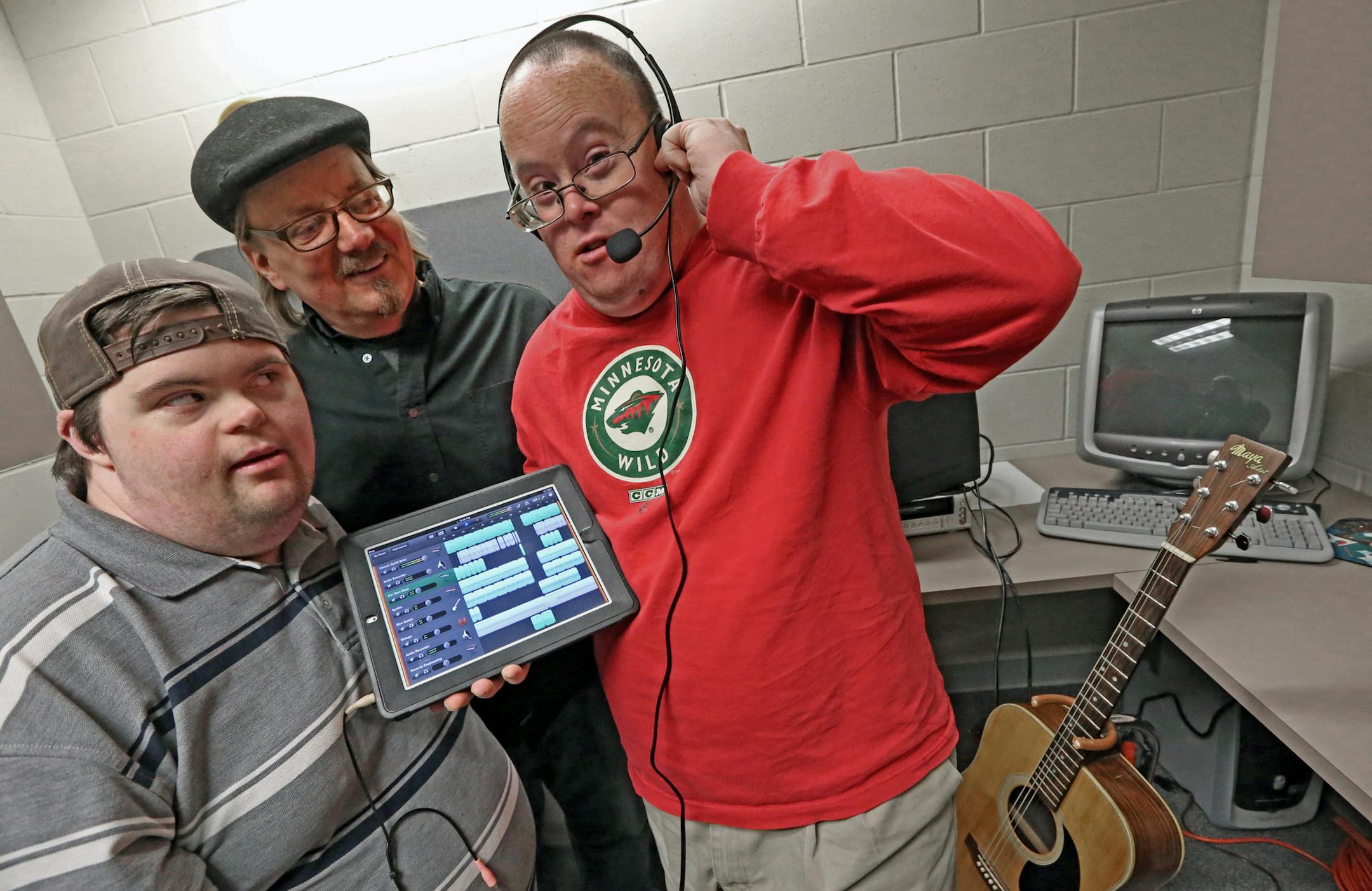 (left to right) "Dance at Your Own Risk," and Achieve Services, Matt Grieser, Joe Loskota, music director and Kelly McAlpin were photographed with the IPad that they created a new CD that will be released shortly before Christmas. One member of this musical group has limited communication skills, but offers a great rock 'n' roll scream. Another, whose ability to communicate also is limited, offers great cadence. None of the members plays an instrument. The group is called "Dance at Your Own Risk