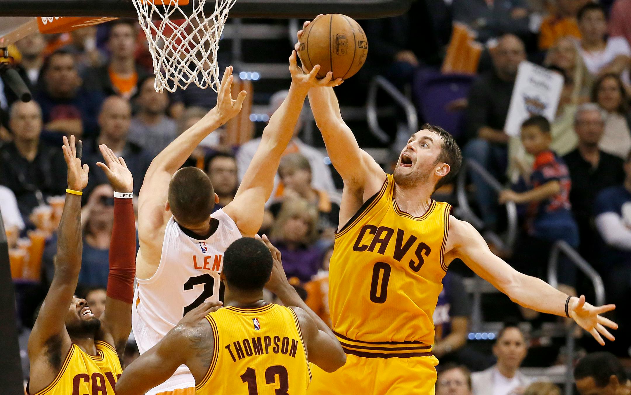 Cleveland Cavaliers' Kevin Love (0) block the shot of Phoenix Suns' Alex Len during the first half of an NBA basketball game, Tuesday, Jan. 13, 2015, in Phoenix. (AP Photo/Matt York)