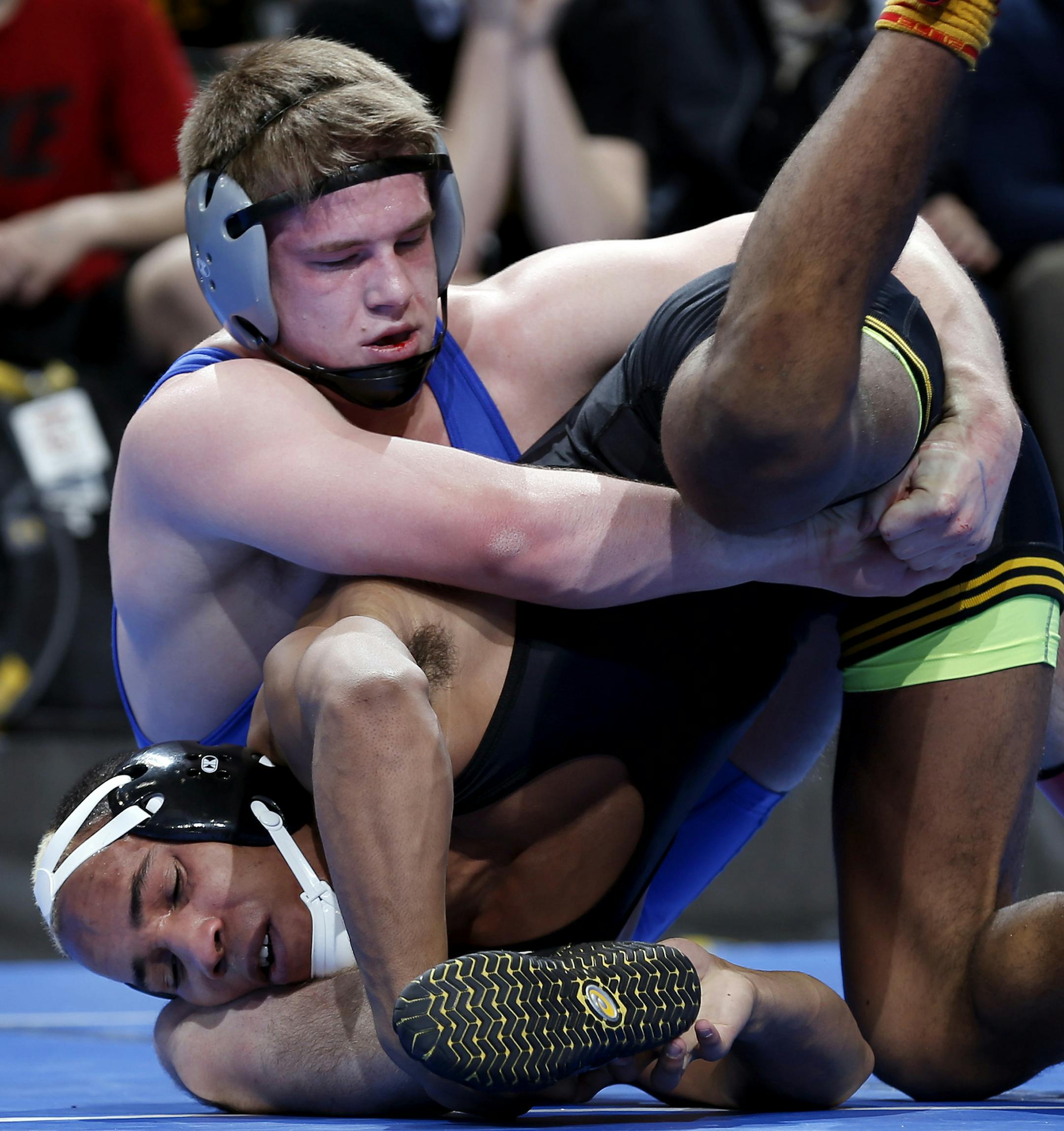 Apple Valley's Daniel Woiwor and St. Michael-Albertville's Ryan Rostamo tangled up in the 160 lb. class. ] CARLOS GONZALEZ cgonzalez@startribune.com - February 28, 2013, St. Paul, Minn., Xcel Energy Center, Minnesota High School Wrestling State Tournament, ORG XMIT: MIN1302282154240331