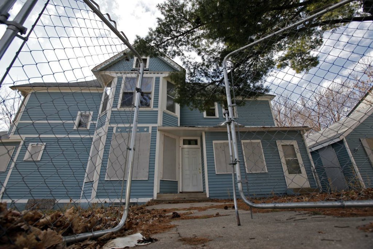 The first floor windows were boarded up on a home on the 2400 block North Bryant Ave in North Minneapolis.