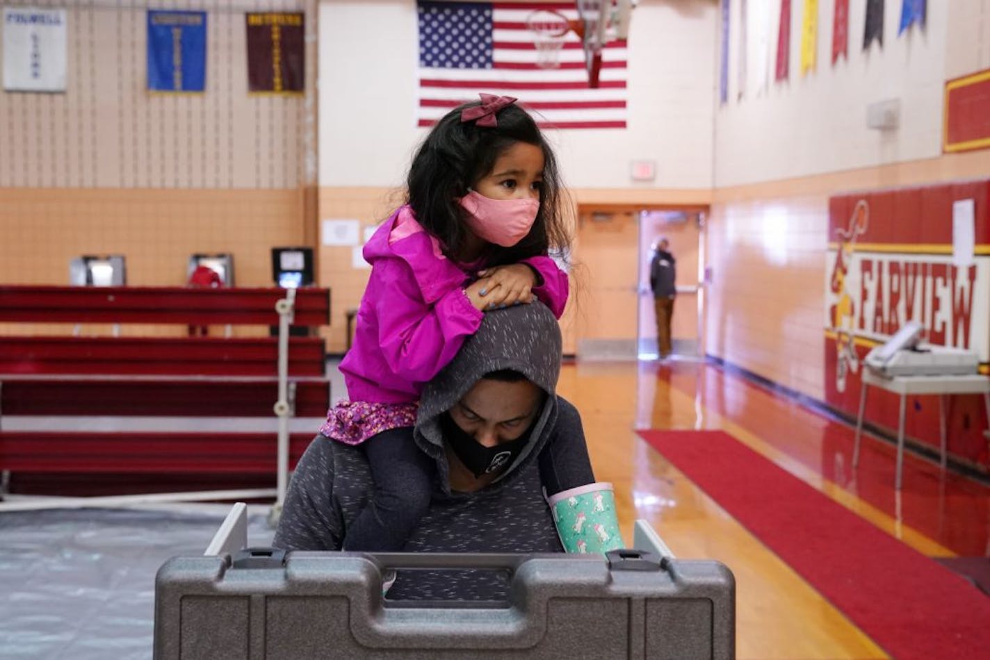 Elliana Mulari, 3, sat atop her dad Timothy's shoulders as he voted at the Farview Park Recreation Center polling location in north Minneapolis on Election Day.