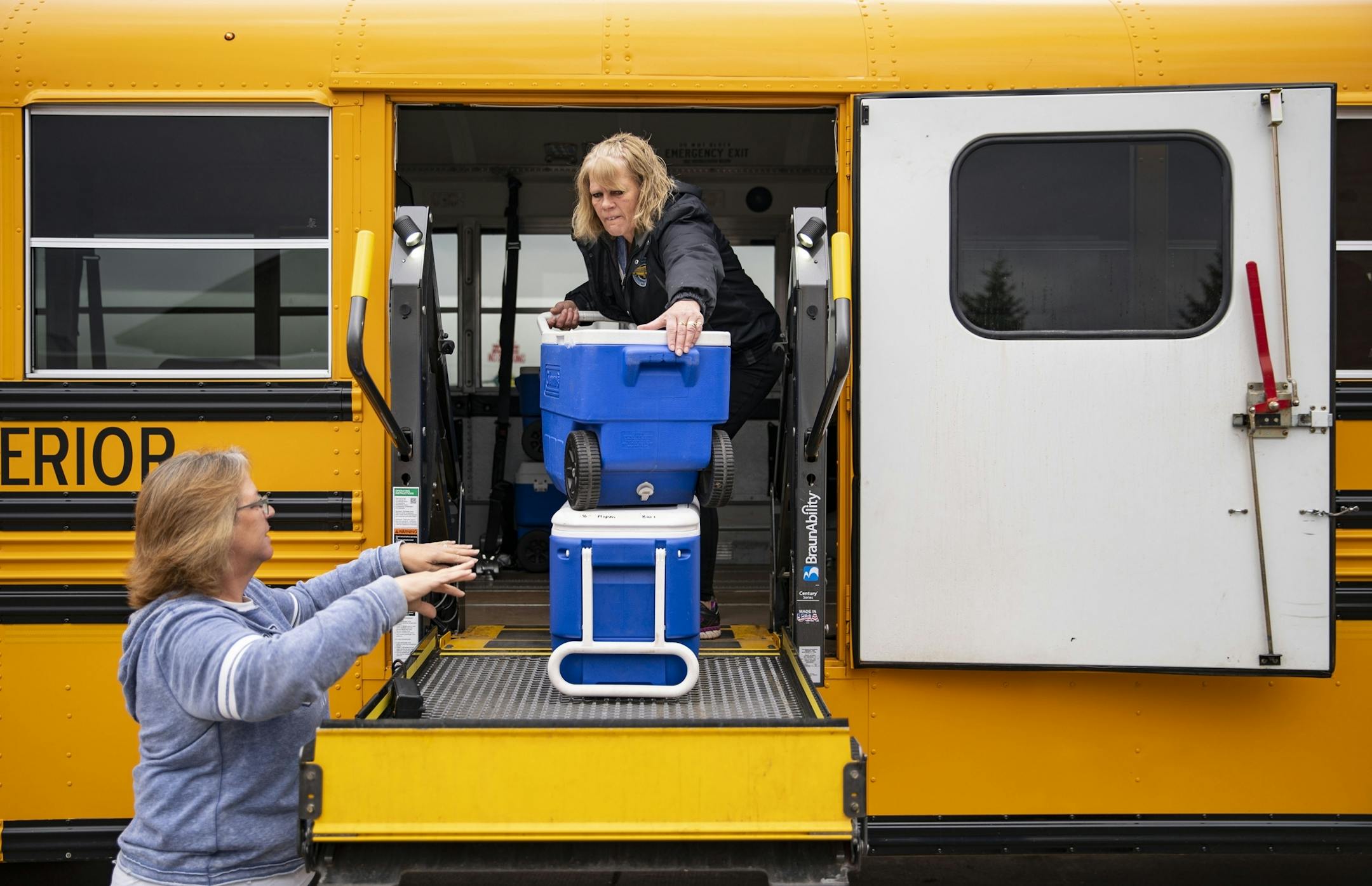 Superior School District special ed assistant Lisa Flyen loaded coolers filled with pre-packed lunch onto a bus at Superior Middle School on Wednesday morning.