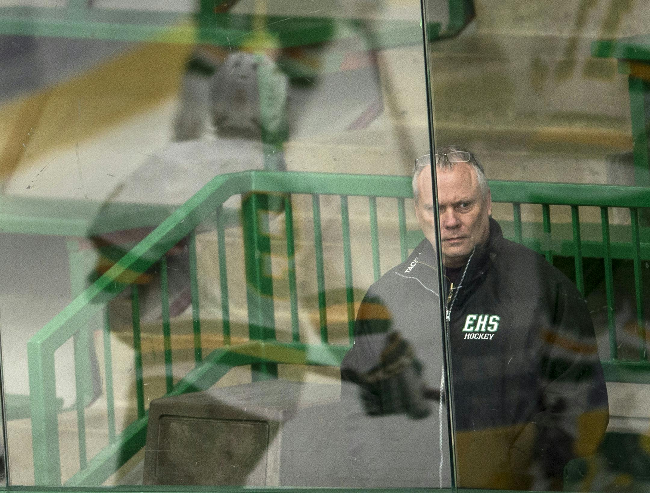 Edina boys' hockey head coach Curt Giles watches his team warmup from behind the glass before Thursday night's game against Hopkins. ] (Aaron Lavinsky | StarTribune) The Edina Hornets take on the Hopkins Royals Thursday, Jan. 22, 2015 at Braemar Arena in Edina. The game was photographed for a feature on Edina head coach Curt Giles. ORG XMIT: MIN1501222332385726