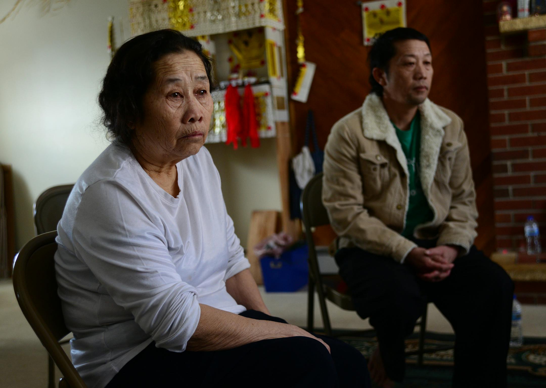 At left is Chue Lor's mother, Mai Thao, who lived with him in the St. Paul apartment where the deadly fight occurred. At right is Chue Lor's older brother, Lee Lor.