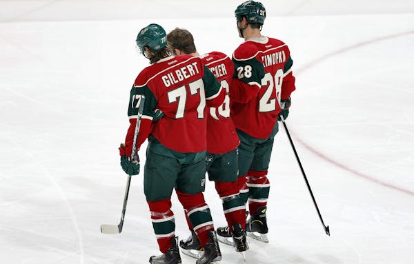 Tom Gilbert (77) and Zenon Konopka (28) helped Jason Zucker (16) off the ice in the second period.