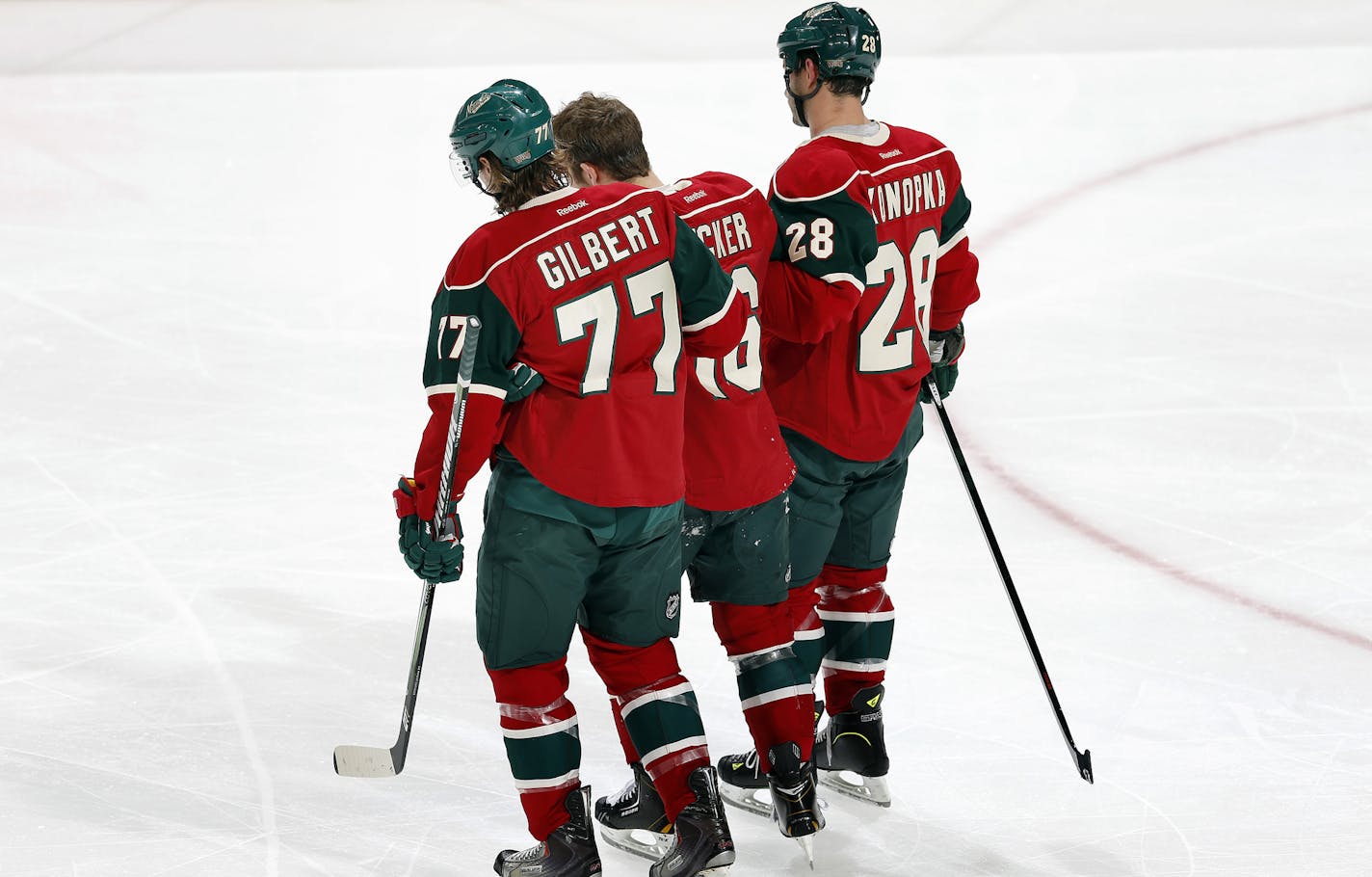 Tom Gilbert (77) and Zenon Konopka (28) helped Jason Zucker (16) off the ice in the second period.