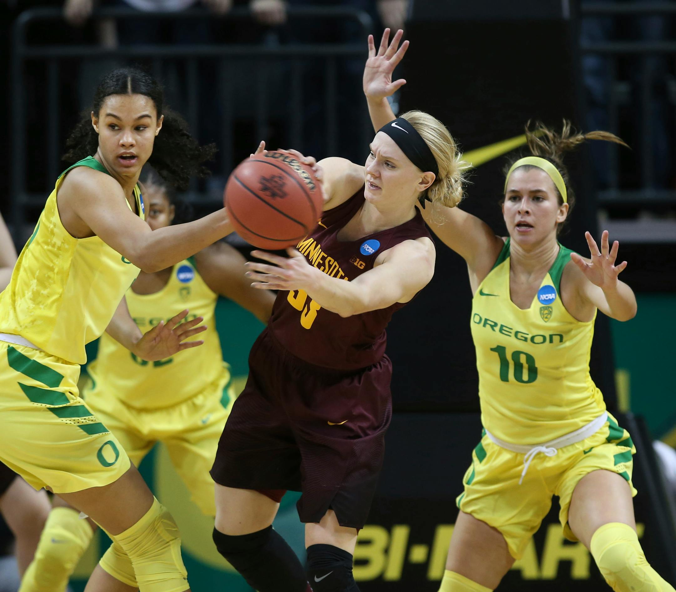 Oregon's Satou Sabally, left, Oti Gildon, center left, and Lexi Bando, right, pressure Minnesota's Carlie Wagner, center, during the second half of their second-round game in the NCAA women's college basketball tournament in Eugene, Ore., Sunday, March 18, 2018. Oregon won 101-73. (AP Photo/Chris Pietsch)
