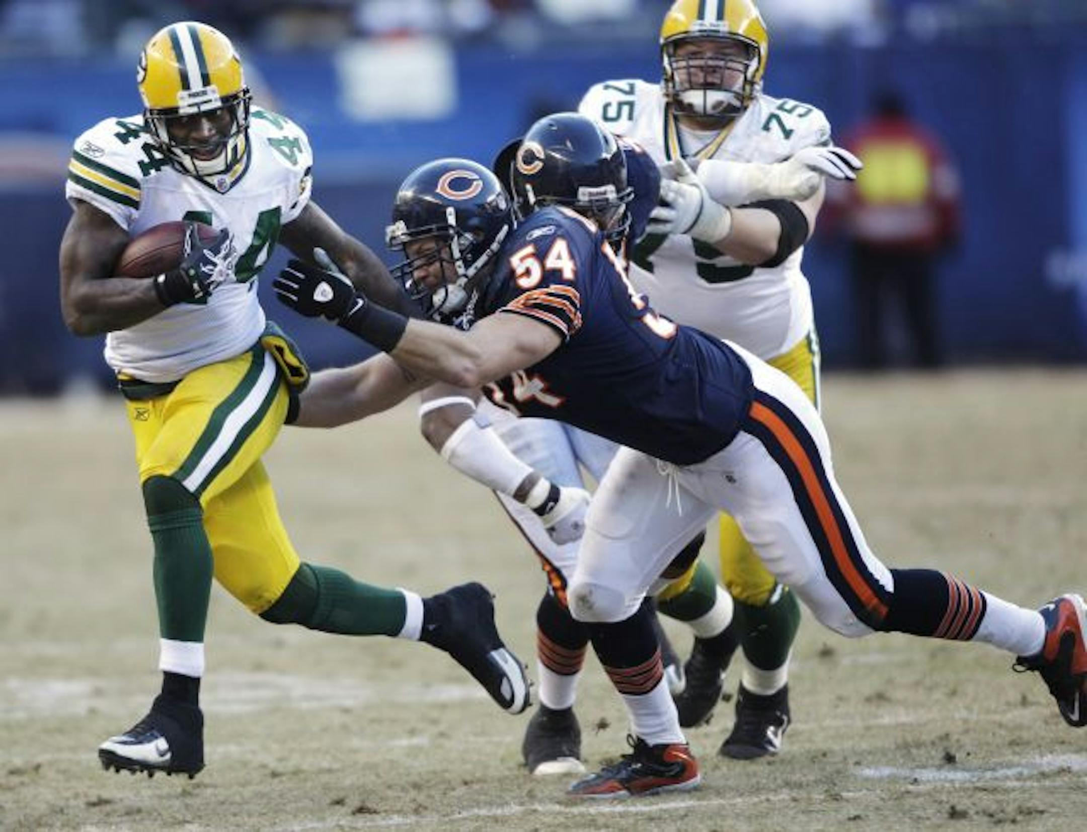 Chicago Bears linebacker Brian Urlacher (54) reaches out to tackle Green Bay Packers running back James Starks (44) during the second half of the NFC Championship NFL football game Sunday, Jan. 23, 2011, in Chicago.