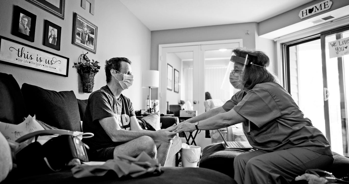 Rick Huggins worked with an M Health Fairview occupational therapist during his first in-home session in late May. She was checking to see the strength of his squeeze. ] aaron.lavinsky@startribune.com Photos to accompany Reid Forgrave's story about five Minnesotans and how they have faced the COVID-19 pandemic, photographed Thursday, May 21, 2020. ORG XMIT: MIN2006302152490257