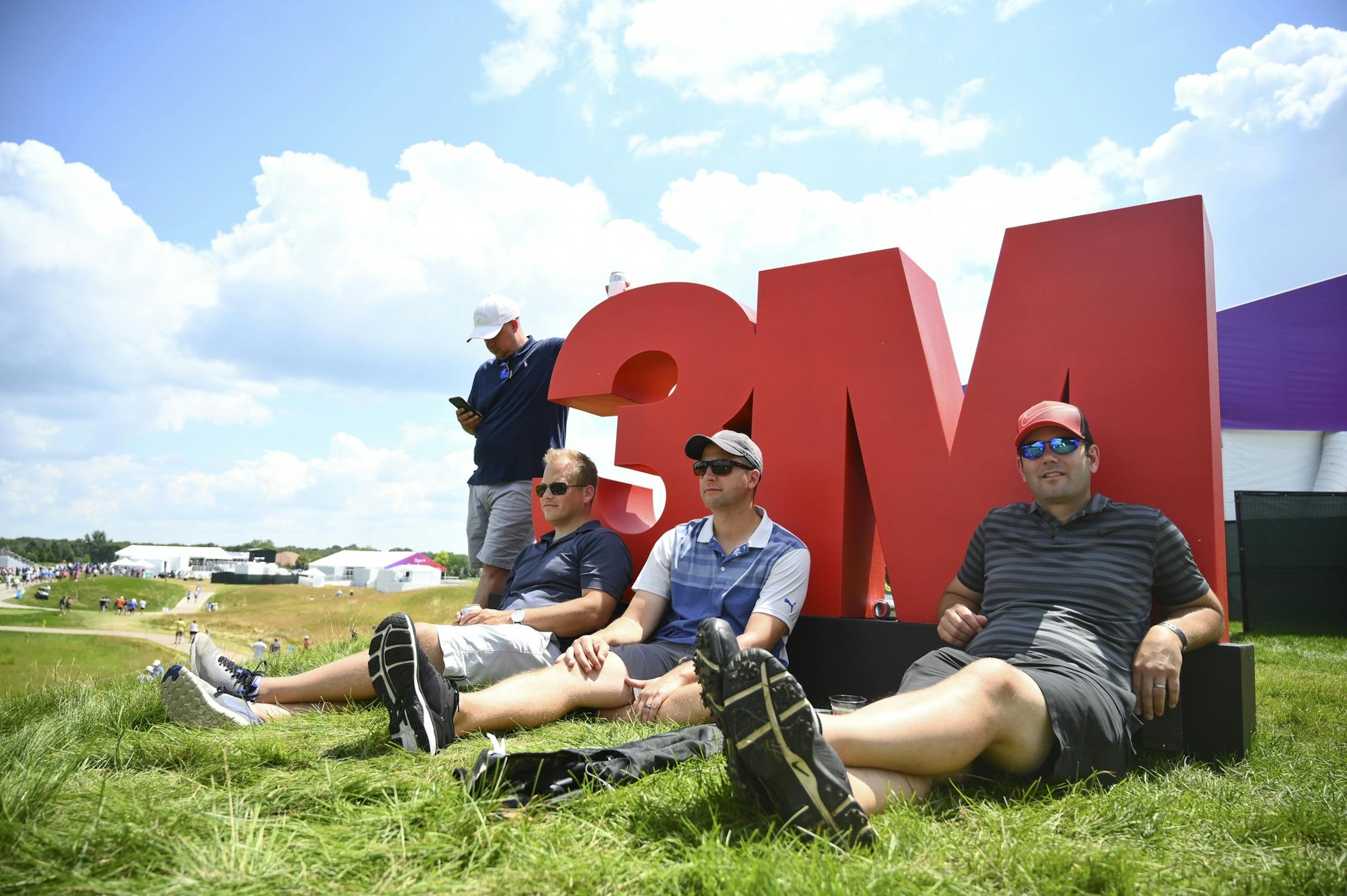 From left, friends Jerry Icarella, Brady Tomlinson, Ryan Sypherd and Joel Rice watched action at the 18th hole from near the Champions Club Saturday.