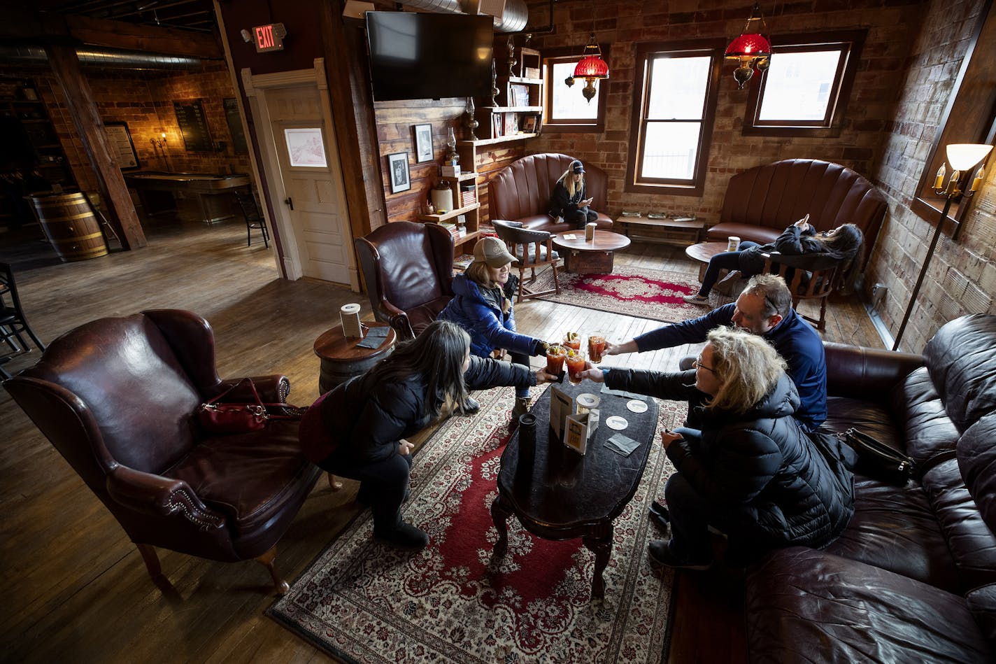 Patrons toasted each other at 10,000 Drops Craft Distillers in Faribault. ] CARLOS GONZALEZ &#x2022; cgonzalez@startribune.com &#x2013; January 13, 2019, Faribault, MN, magazine vignette on how Faribault is one of the small hip towns to visit outside the Twin Cities.,