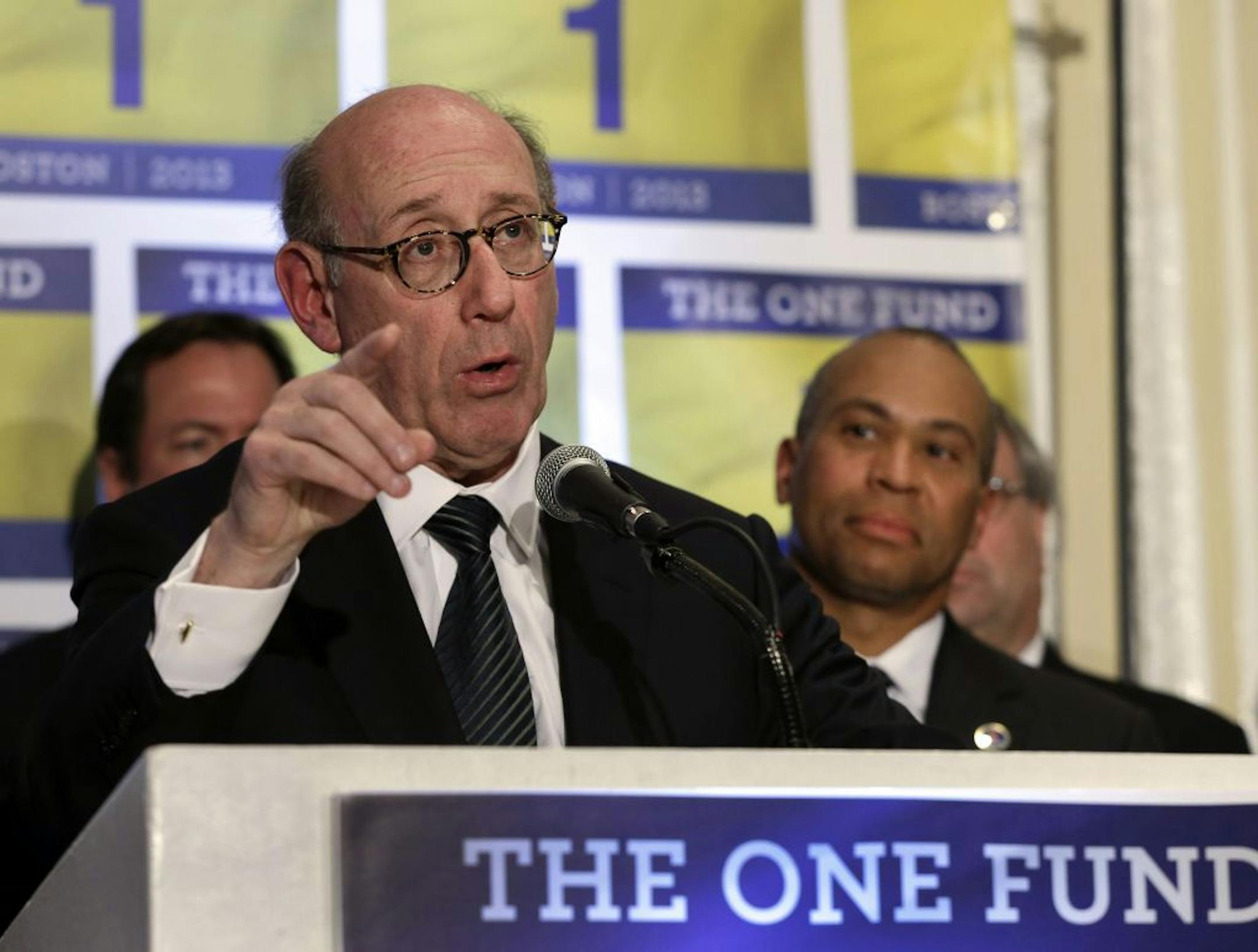 FILE - In this Tuesday April 23, 2013 file photo, Kenneth Feinberg, an attorney who managed the 9/11 Victim Compensation Fund, speaks at a news conference in Boston, as Massachusetts Gov. Deval Patrick listens at right. Feinberg will design and be administrator of a new fund to help people affected by the Boston Marathon bombing. Patrick and Boston Mayor Thomas Menino say the One Fund Boston is intended as a central place to gather donations for the Boston Marathon bombing victims.