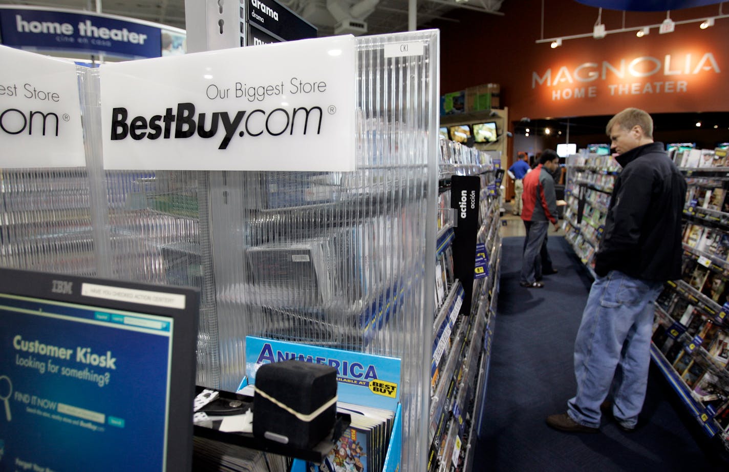 A customer looks for video tapes at Best Buy in Mountain View, Calif., Monday, Dec. 15, 2008. Best Buy Co., the nation's biggest consumer electronics retailer, said Tuesday that its third-quarter profit sank as it faced dramatic changes in consumer spending and added it will offer buyout packages to nearly all its corporate employees in an effort to cut costs.