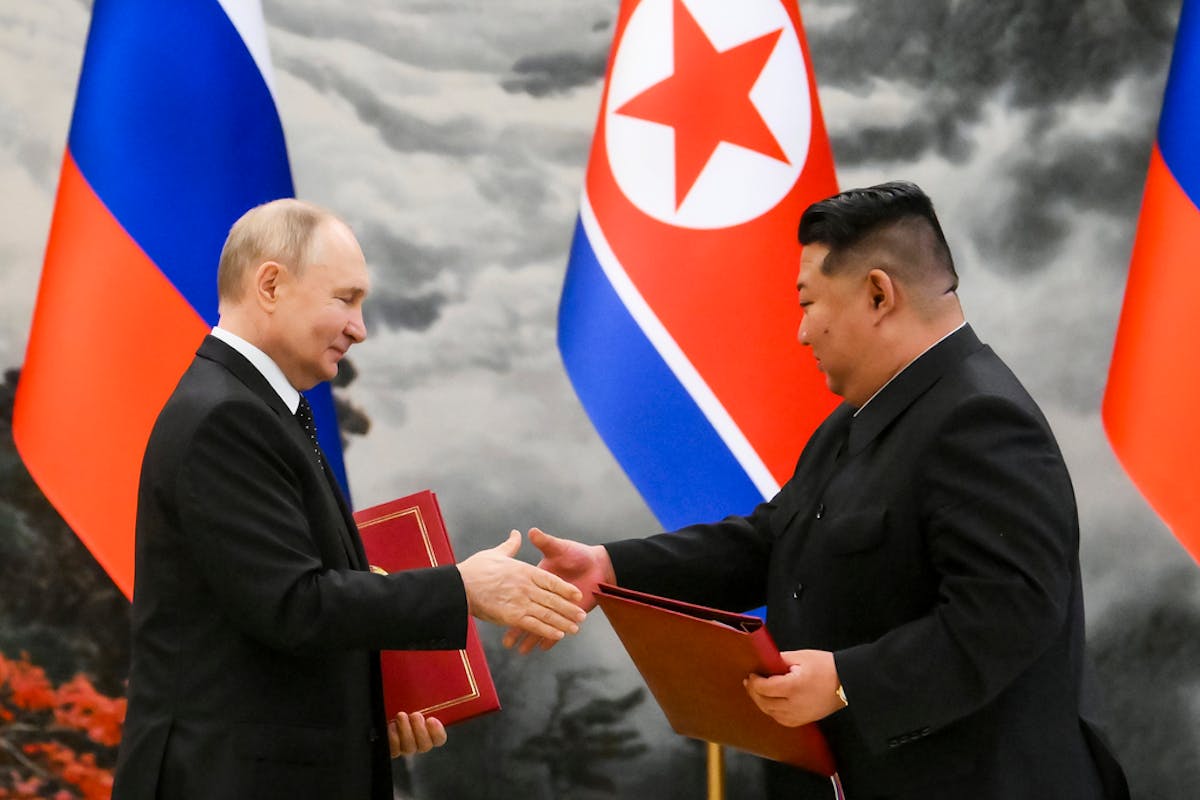Russian President Vladimir Putin, left, and North Korea's leader Kim Jong Un exchange documents during a signing ceremony of the new partnership in Py