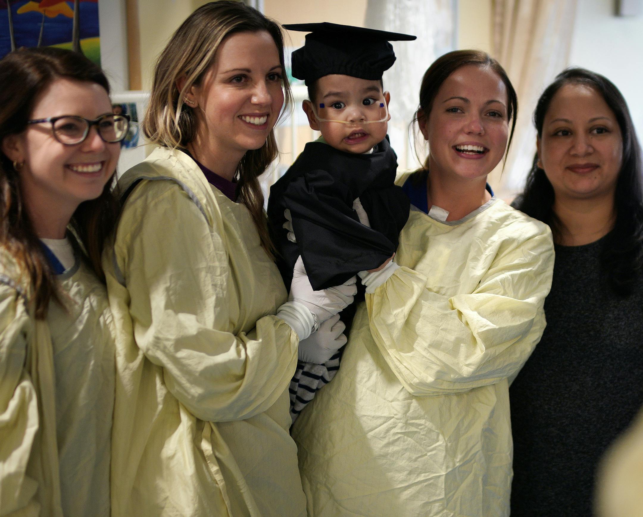 Oliver Rodriguez-Ocampo and his mother Manuela, right, with Oliver's nurses Katie Christoperson, Sarah Ghizoni and Lindsay Powell.