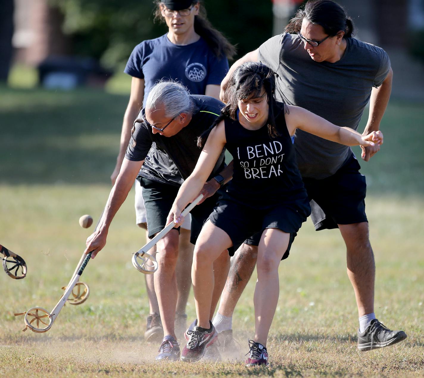 Sasha Houston Brown, center, battled for the ball during an evening of the Creator's game, which closely resembles lacrosse, in a Minneapolis park.