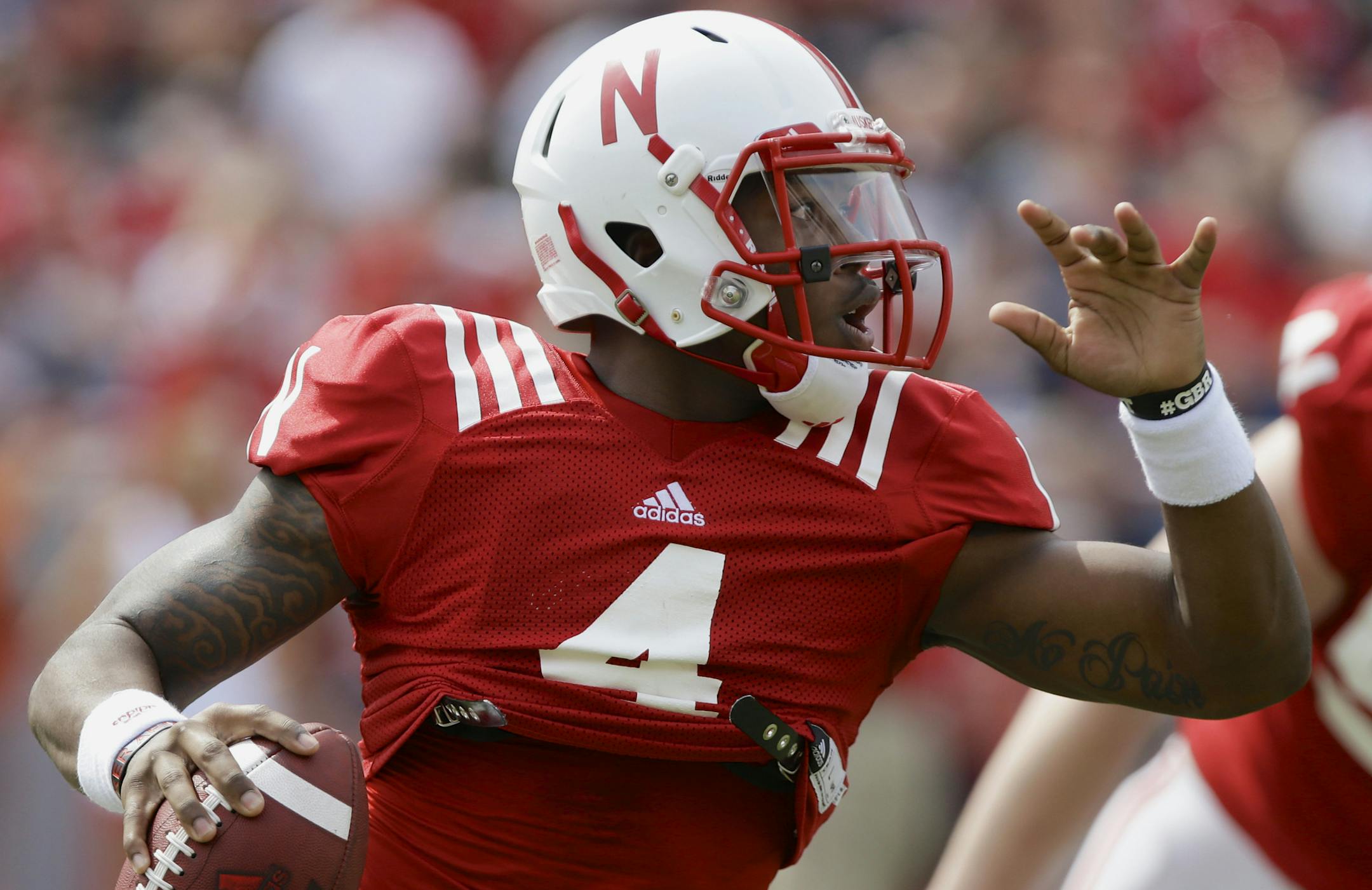 Nebraska quarterback Tommy Armstrong Jr. rolls out of the pocket during Nebraska's NCAA college football spring game in Lincoln, Neb., Saturday, April 12, 2014. (AP Photo/Nati Harnik) ORG XMIT: NENH104