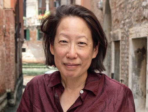 photo of author Gish Jen in front of ancient buildings