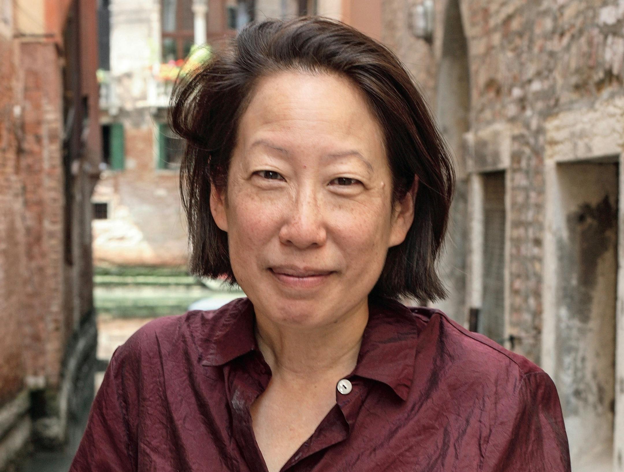 photo of author Gish Jen in front of ancient buildings