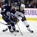 Winnipeg Jets' Andrew Copp (9) and Minnesota Wild's Gustav Olofsson (23) battle for the puck during second period NHL hockey action in Winnipeg, Manit