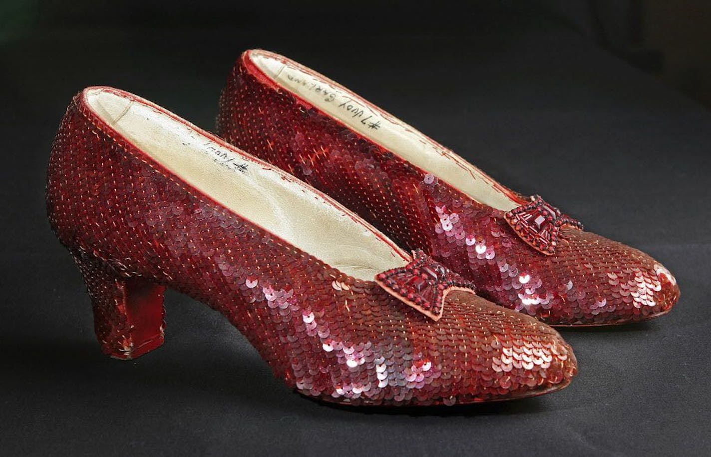 File- This Nov. 9, 2001, file photo shows the sequin-covered ruby slippers worn by Judy Garland in "The Wizard of Oz."