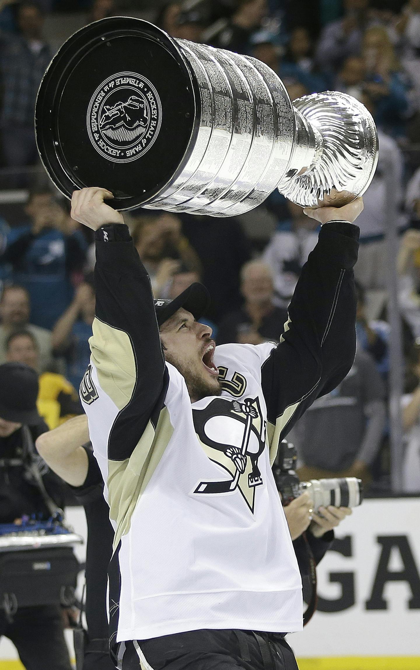 Pittsburgh Penguins center Sidney Crosby celebrates with the Stanley Cup after Game 6 of the NHL hockey Stanley Cup Finals against the San Jose Sharks in San Jose, Calif., Sunday, June 12, 2016. The Penguins won 3-1 to win the series 4-2. (AP Photo/Marcio Jose Sanchez)