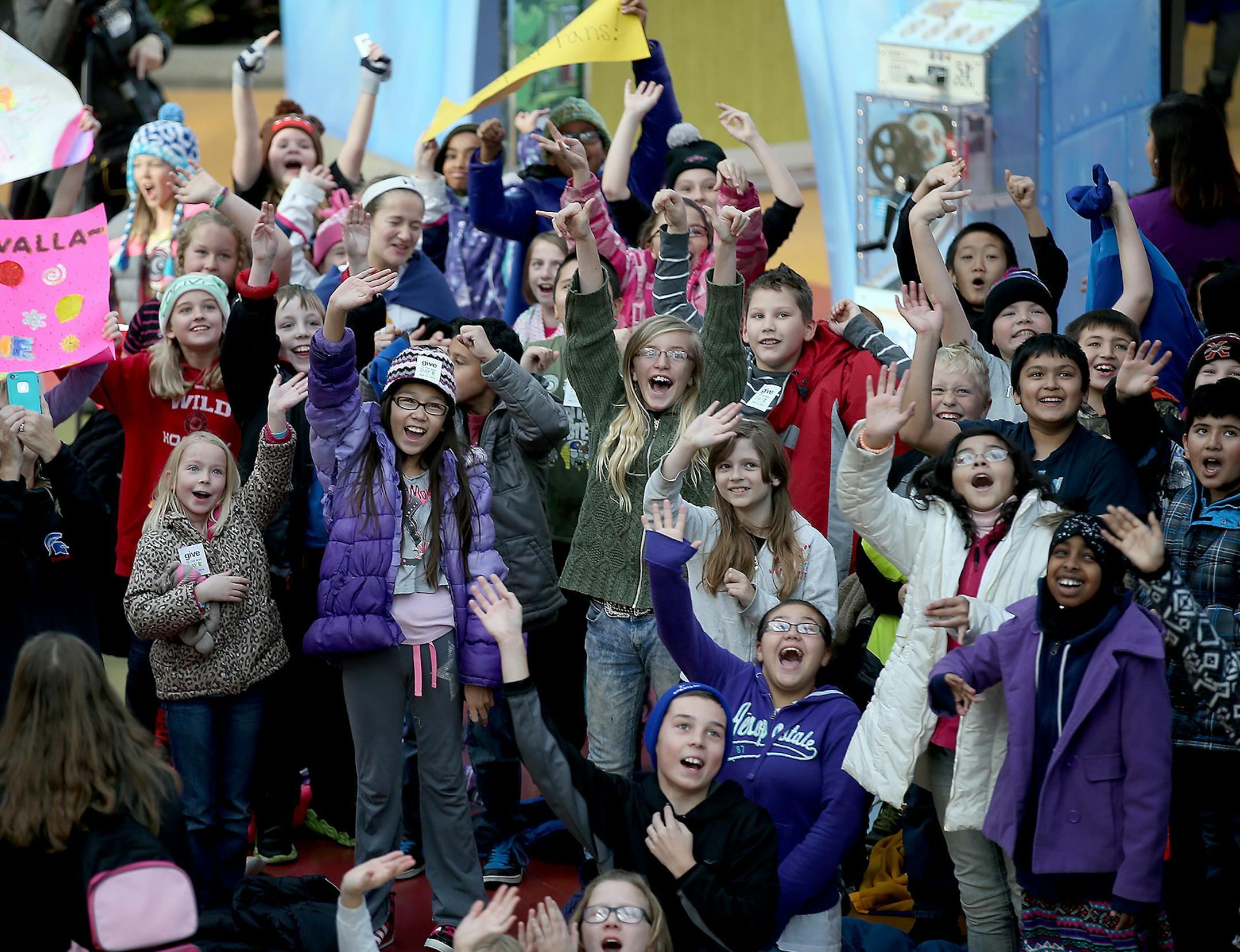 Hilltop Elementary School students cheered on their principal Sue Vallafskey as she swung high above the Mall of America's Zip Line, Thursday, November 13, 2014 in Bloomington, MN. Vallafskey joined other school principals and teachers to gain awareness for "Give to the Max" day, the annual giving extravaganza that raised $17 million in 24 hours last year. ] (ELIZABETH FLORES/STAR TRIBUNE) ELIZABETH FLORES &#x2022; eflores@startribune.com