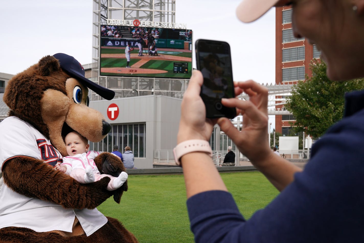 Chrissie Olson took a photo of her 5-month-old daughter Marion as T.C. Bear jokingly took a bite of the youngster during a free "Post-season Push" party to watch the Twins play the Tigers in Detroit last month.