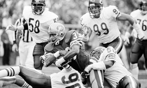 San Francisco 49ers fullback Roger Craig (33) can't escape the grips of Chicago Bears linebackers Mike Singletary (50) and Al Harris (90) and is stopped for just one yard on the Bears' three-yard line during the second quarter, on Jan. 6, 1985 NFC championship game in San Francisco. (AP Photo/Mclendon) ORG XMIT: APHS131395