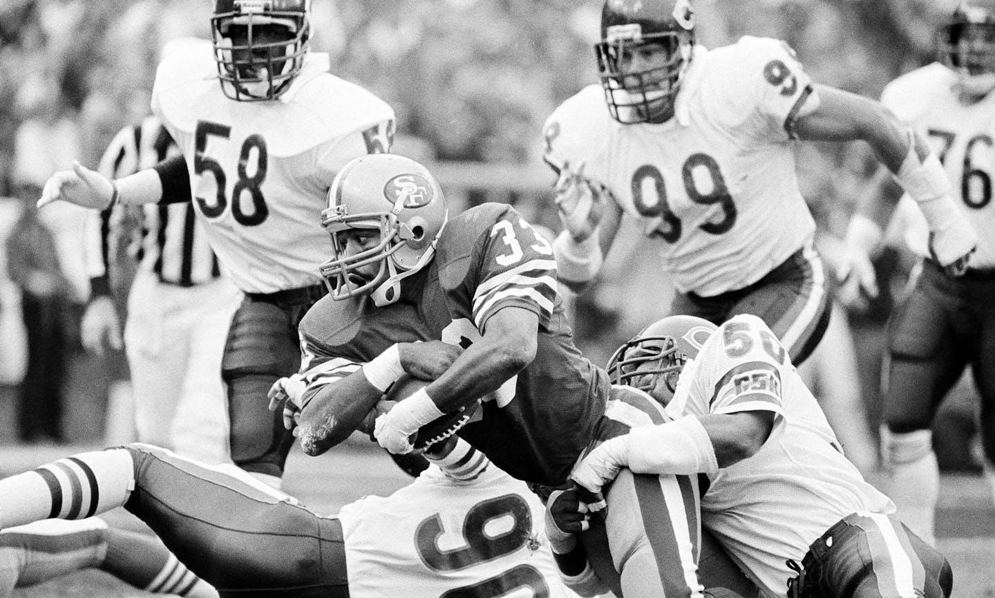 San Francisco 49ers fullback Roger Craig (33) can't escape the grips of Chicago Bears linebackers Mike Singletary (50) and Al Harris (90) and is stopped for just one yard on the Bears' three-yard line during the second quarter, on Jan. 6, 1985 NFC championship game in San Francisco. (AP Photo/Mclendon) ORG XMIT: APHS131395