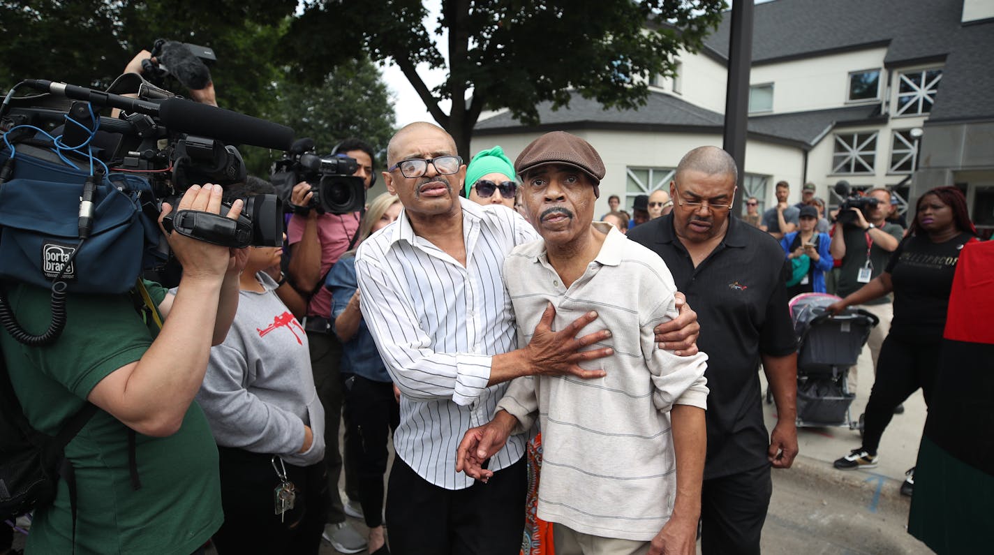 Thurman Blevins' brother Manuel Moore, left, escorted his father Thurman Moore to their car after speaking during a protest and rally at the Fourth Precinct.