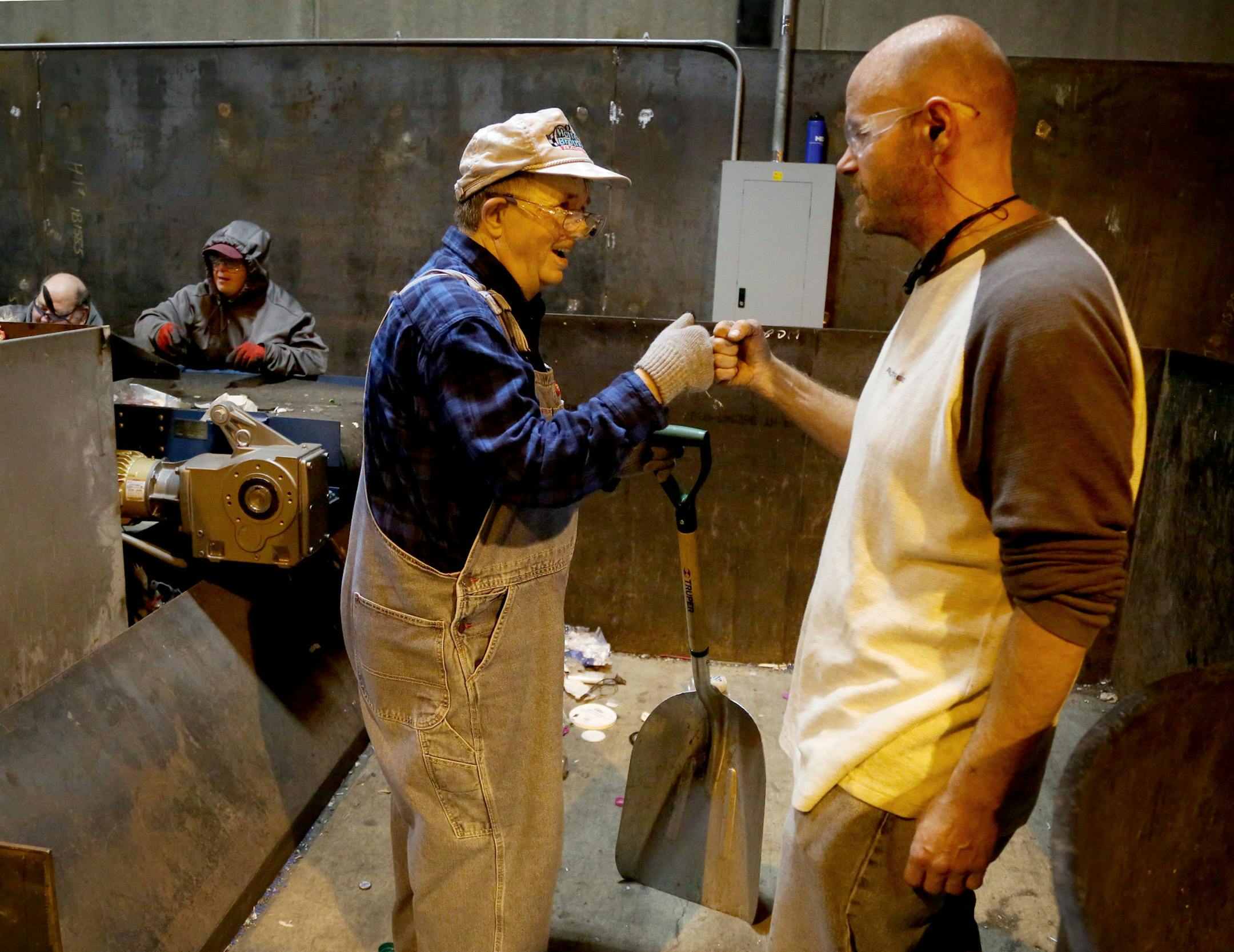 Disabled workers like John Week, 37, have opportunities that they never thought possible. Workers who once toiled for years in dead-end jobs are now making up to $14 an hour at an MDI facility and have opportunities for advancement. Here, Week fists bumps an employee after praising the worker for his effort and telling the worker that he likes his overalls Tuesday, Sept. 27, 2016, in Cohasset, MN. ](DAVID JOLES/STARTRIBUNE)djoles@startribune.com For years, Minnesota Diversified Industries in Gra
