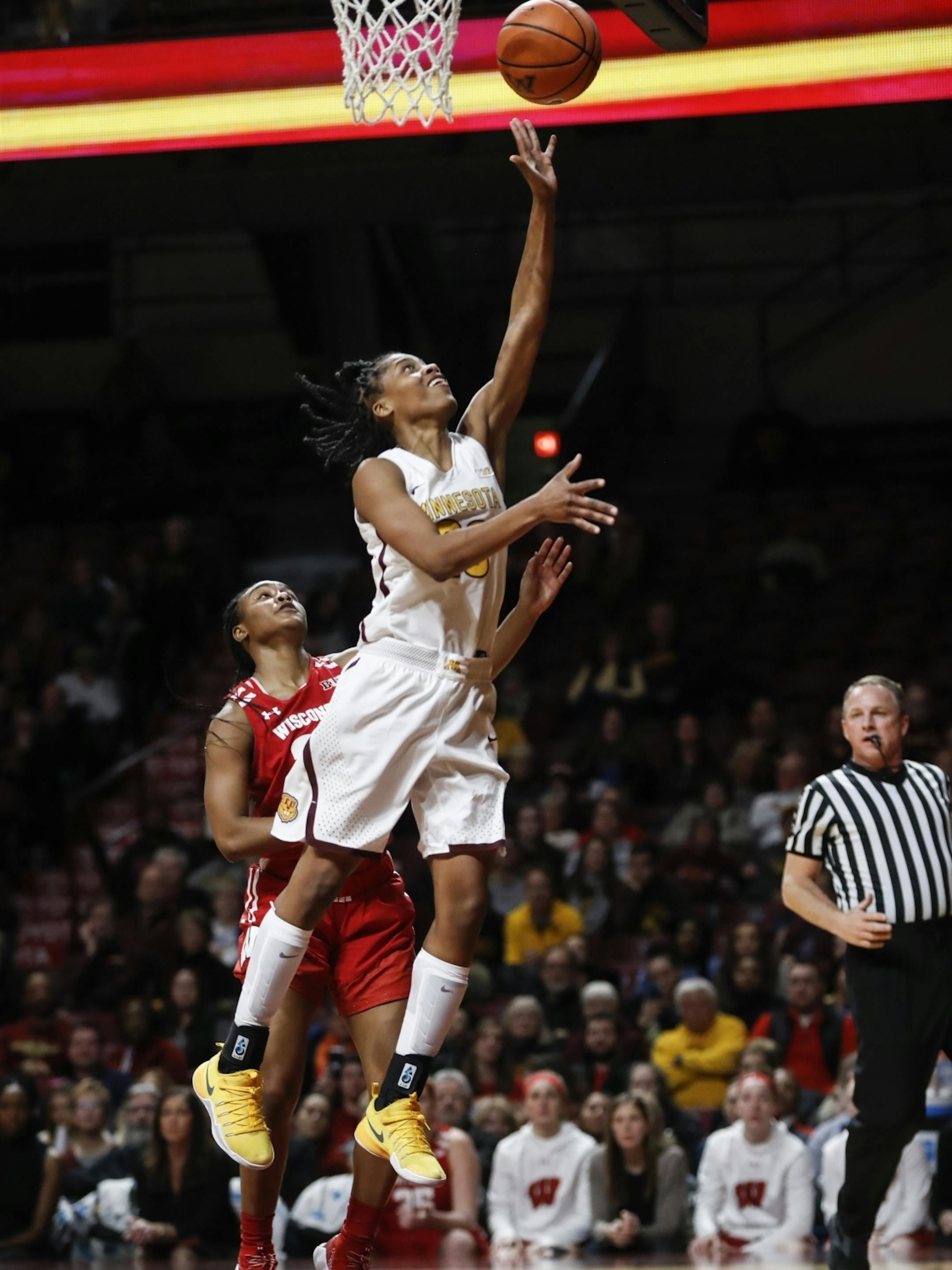 Minnesota Golden Gophers guard Kenisha Bell (23) drives to the basket for two points in the first half.